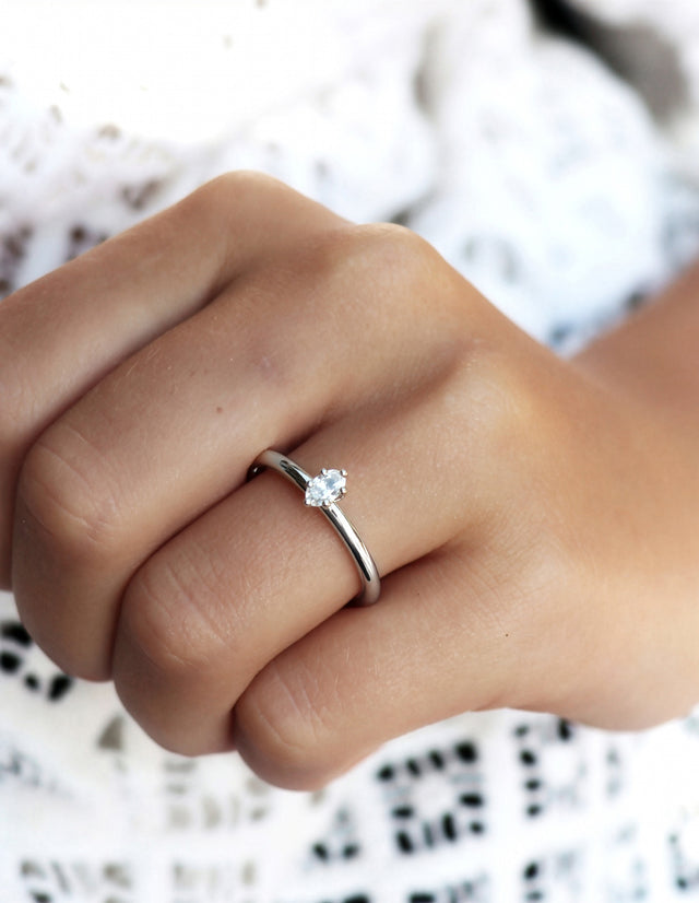 Tjej som bär en förlovningsring i silver med oval diamant 0,25 ct. 